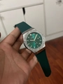 Close-up of women's quartz watch featuring a green dial with sparkling crystal bezel - Silver Case Green Silicone Strap