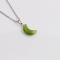 Close-up of polished green crescent moon pendant with a silver metal chain necklace - Green