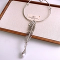 Detail of silver fishbone pendant with S925 stamp and an irregular pearl on display - Silver
