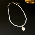 Detail of a gold rose pendant on a delicate rice pearl necklace against black leather - 3# Necklace - White Rose Pearl