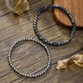Double layered hematite beaded bracelets featuring dark metallic tones on rustic wood - 2 Pcs Set Hematite Polyhedron Round Beads Combo