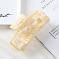 Macro shot of a rectangular hollow hair claw clip with creamy marble acetate texture - 2# Yellow 10cm Acetate Claw Clip