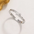 Elegant silver-tone clover bangle with zircon stones on a clean textured background - Steel