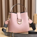 Pink woven bucket bag with gold hardware and geometric patterned wide shoulder strap - Woven-Pink