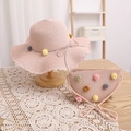 Pink straw hat and matching bag set for kids with colorful pom-poms and bow details - Pink Hat + Bag