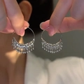 Detail of silver C-shaped irregular earrings with cascading tassel fringe on model - 11# Ear Hook - Regular - Silver