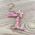 Pink resin letter L keychain with butterfly charm and tassel on golden chain - Letter L