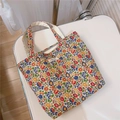 Detailed top view of a colorful floral cotton canvas tote bag with a zipper and branded label - Red Orange Blue Small Flower
