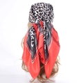 Square satin scarf with leopard print and geometric borders worn as a stylish headscarf - Coral Red Leopard