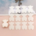 Detailed view of thirteen white bear-shaped DIY charms with golden borders for phone cases - Bear Stickers(K6227) / White