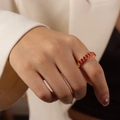 Elegant gold-plated geometric ring with oval-cut red zircons worn by a model - B-Style Red