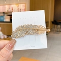 Golden feather hair clip with sparkling rhinestones on a white display card - #84 Golden Feather