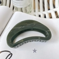Close-up of a large dark green crescent hair claw clip on a white magazine page - Butterfly Buckle 10cm / Dark Green