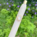 Detail shot of 18K gold plated ring with Mother Mary motif and zircon stones on a leather stand - White