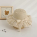 Detail of a cute girl's straw sun hat with lace bow and polka dot tulle brim - Hat / Beige
