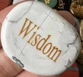 Polished white turquoise oval stone engraved with gold Wisdom lettering - Howlite