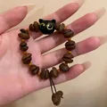 Handcrafted coffee bean beaded bracelet with a cute black cat pendant and resin charms - Coffee Bean Cat Bracelet