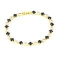 Detalle de pulsera tenis en oro 18k con circonitas de trébol blanco y negro y cierre de langosta - Multicolor