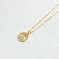 Macro shot of gold-plated religious pendant featuring micro-pave zirconia on fine O-chain - Religious Figure Round Medal