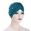 Ruched pleated turban hat in deep teal with white pearls and silver beads on mannequin - Peacock Blue