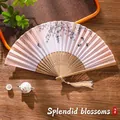 Traditional Chinese folding fan in light yellow with floral prints and bamboo ribs - 21 Splendid Flowers
