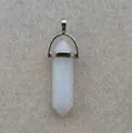 Macro shot of white hexagonal crystal pendant with a polished silver metallic bail - White Stone