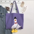 Detail of purple canvas tote bag featuring 3D plush goose feet and gentleman goose print - Cane Duck Purple