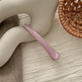 Detail of a light purple seamless hair clip on a minimalist white stand with soft lighting - Bright Purple