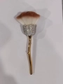 Detail of rose-shaped makeup brush with crystal-studded ferrule and golden stem - Silver Rhinestone Gold Handle Brown & White