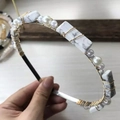 Close-up of handmade headband with white marble stones and pearls woven with gold wire - Gold Wire Silver Headband