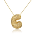 Macro shot of gold bubble letter C pendant necklace with sparkling pavé zircon detail - Letter C (D1079-C)