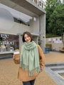 Soft light green thick cashmere scarf with fringe tassels worn by a model in a cafe - Tassel Style / 260g (200x70cm) / Fruit Green