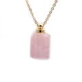 Detail of pink semi-precious stone perfume bottle pendant with gold metal cap on chain - Rose Quartz