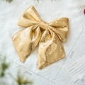 Sparkling gold sequin Christmas bow ornament measuring 20x25cm on snowy background - 20x25cm / Gold