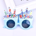 Detail shot of light blue birthday cake party sunglasses with colorful candles and text - Cake Candle Blue