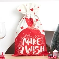 Festive Christmas drawstring gift bag with Make a Wish star print and red white design - Stars & Wish Lettering