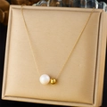 Detailed view of irregular gold bead and white pearl pendant on a sleek chain necklace - Large Pearl with Gold Bead Style (N3308)