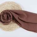 Dark brown chiffon hijab scarf elegantly styled on a woven straw mat backdrop - 126