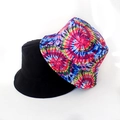 Detail of reversible bucket hat showing black solid side and colorful tie-dye star pattern - Colorful Tie Dye