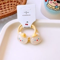 Detail shot of cute white cat resin charms on yellow elastic hair ties for kids - Yellow Cat Style