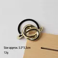 Minimalist gold knot metal hair tie with black elastic band, size 5.5x3.3cm - Knotted Design Gold
