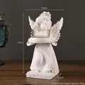 European vintage angel resin candle holder with floral carvings and glass cup in white - Angel Candlestick - Right Facing
