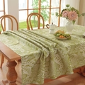 Detail of green leaf pattern tablecloth on wood table with a cozy rustic cotton linen feel - Green Base With White Leaves - Curled Edges / 60*60cm