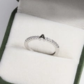 Macro shot of silver letter A rhinestone ring on green velvet jewelry box lining - Platinum A