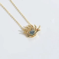Creative gold Devil's Eye necklace with colorful rhinestone eyelashes on white background - Eyelash Eye