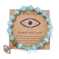 Blue cat eye stone beaded bracelet with gold evil eye charm on display card - 19cm / Blue Cat's Eye