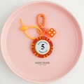 Close-up of orange poker chip keychain with Monte Carlo 5 token and matching dice pendant - Orange Red-5 Value