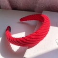 Red chunky knit headband featuring a twist braid pattern and Handmade label - Red