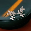 Detail of zircon flower stud earrings with silver finish on luxury green leather jewelry box - Flower Ear Bone Clip / Silver