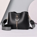 Minimalist black bucket bag with butterfly tassel and wide herringbone strap - Black
